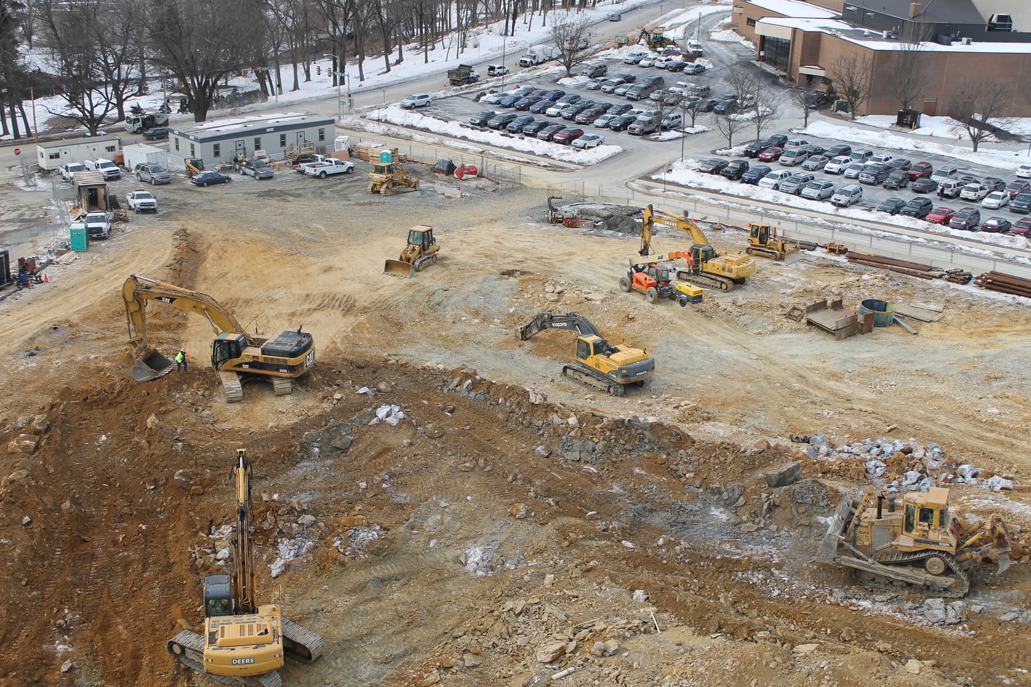 A fleet of excavators and dozers performing rock excavation on a Liberty Excavators jobsite